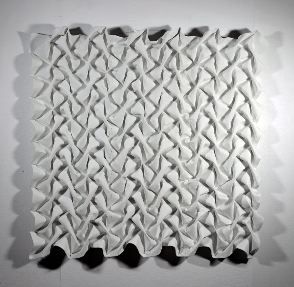 Sculptural wall work made from woven wallpaper